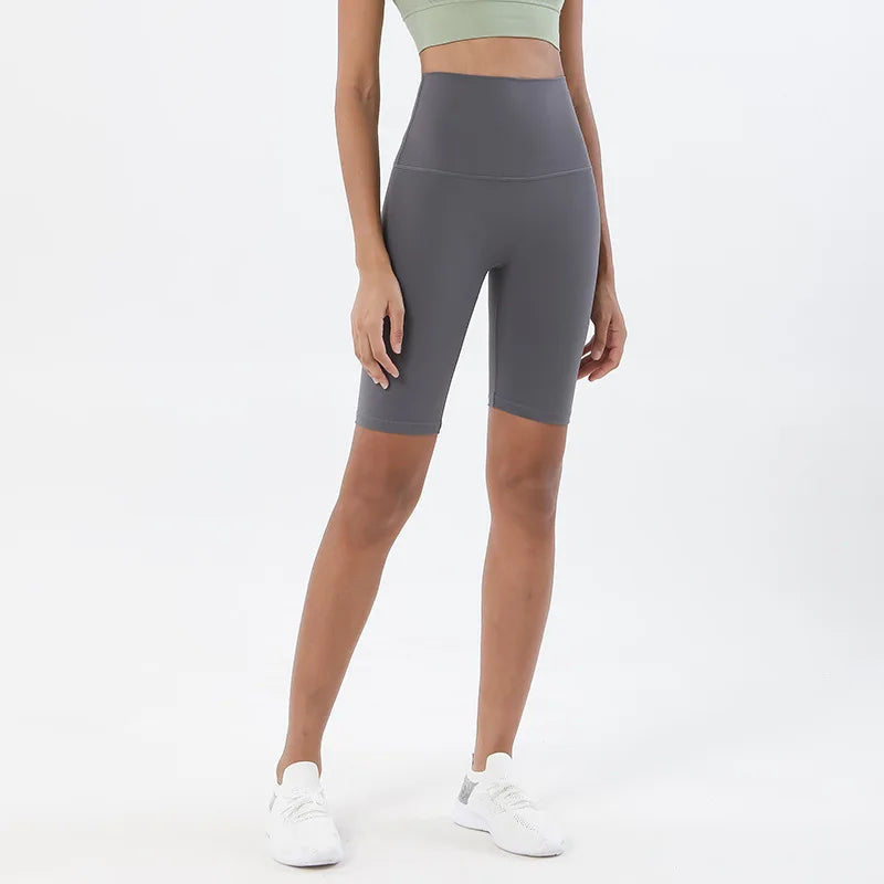 Model wearing titanium grey women’s breathable high-waist cycling shorts, tummy control biker shorts