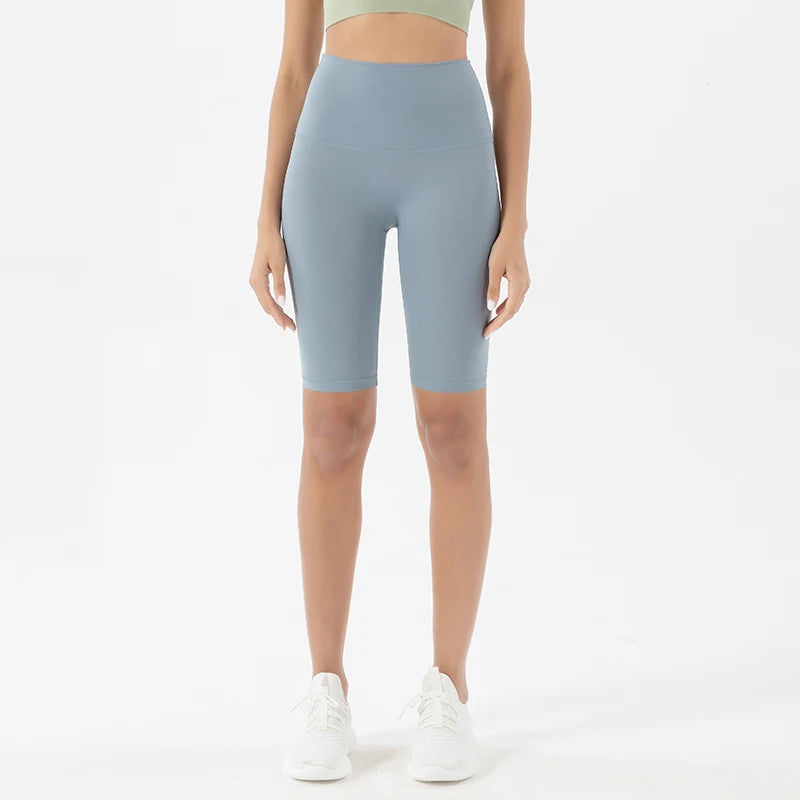 Model wearing light blue women’s breathable high-waist cycling shorts, tummy control biker shorts