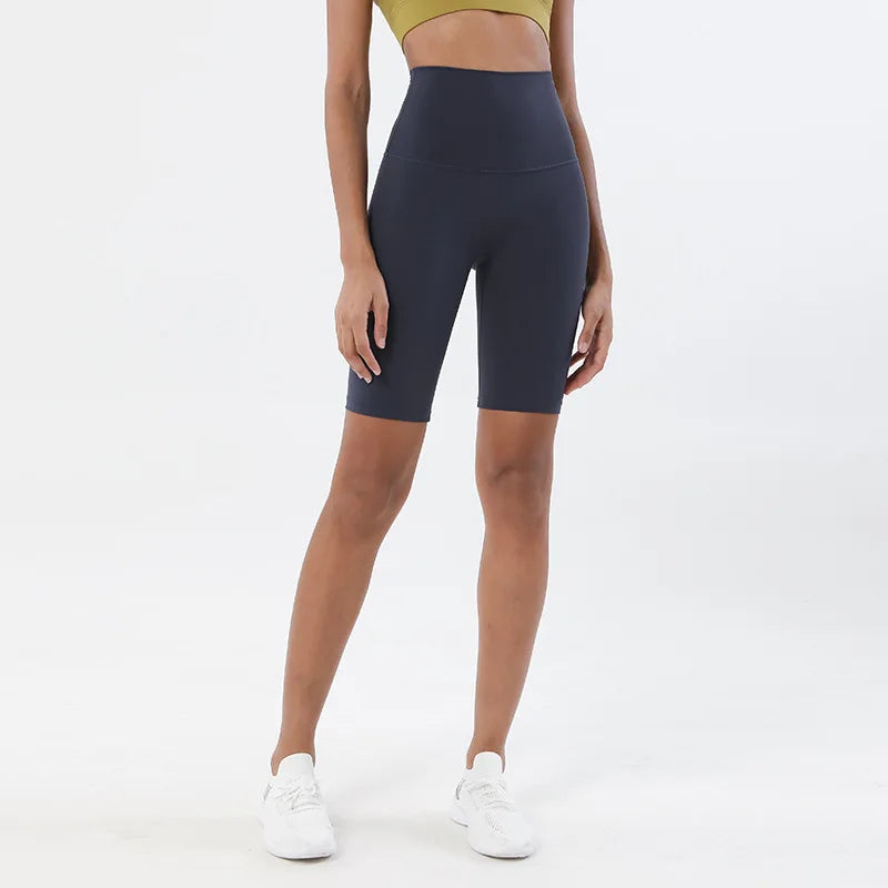 Model wearing dark blue women’s breathable high-waist cycling shorts, tummy control biker shorts