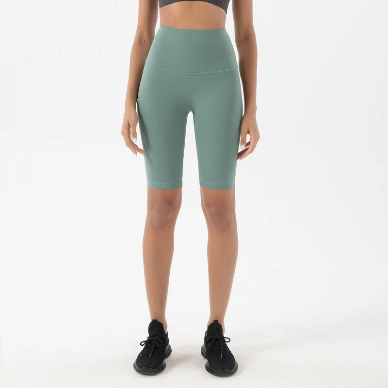Model wearing blue green women’s breathable high-waist cycling shorts, tummy control biker shorts