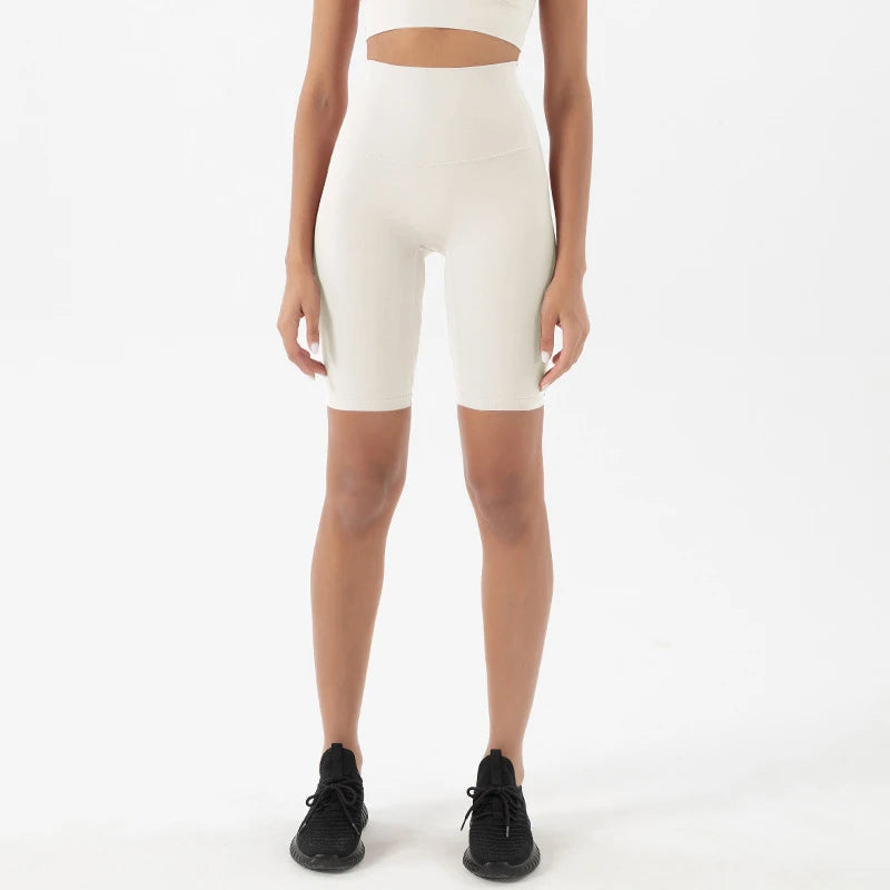 Model wearing white women’s breathable high-waist cycling shorts, tummy control biker shorts