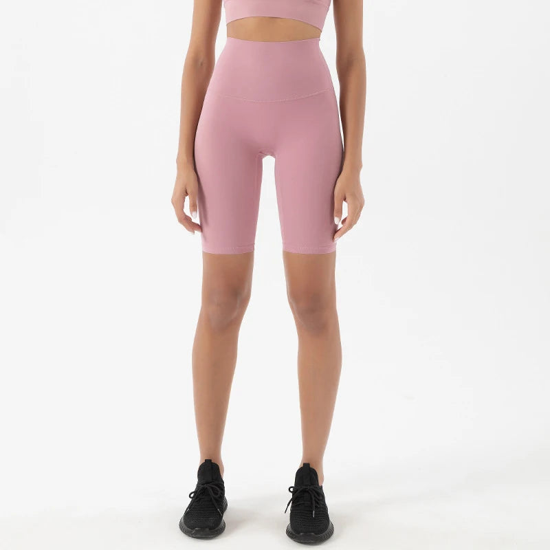 Model wearing pink purple women’s breathable high-waist cycling shorts, tummy control biker shorts