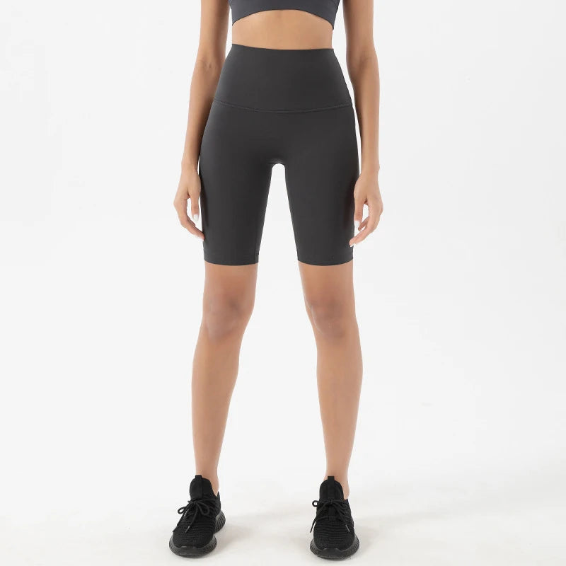 Model wearing dark grey women’s breathable high-waist cycling shorts, tummy control biker shorts