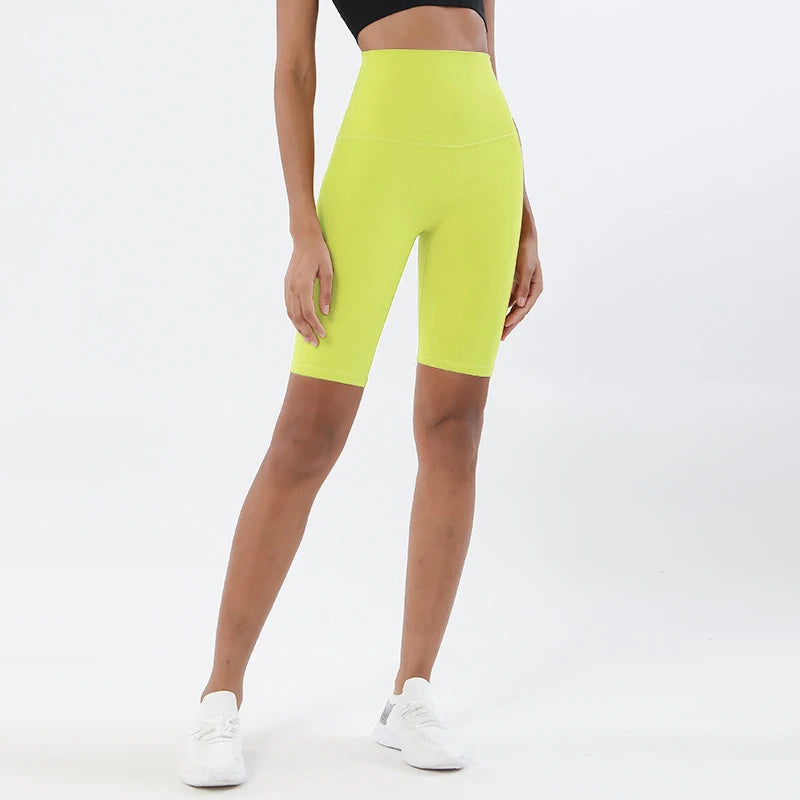Model wearing lemon yellow women’s breathable high-waist cycling shorts, tummy control biker shorts