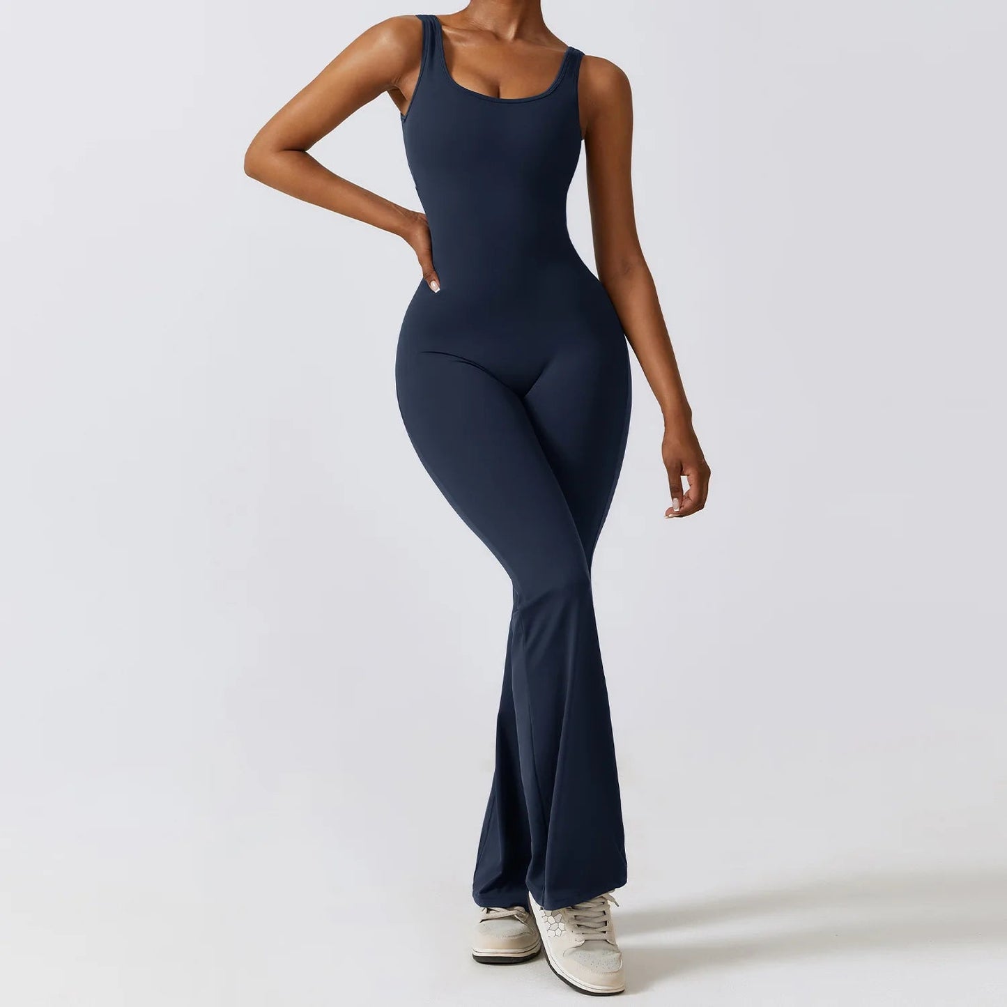 Model wearing blue women’s workout bodysuit, stretchy one-piece romper