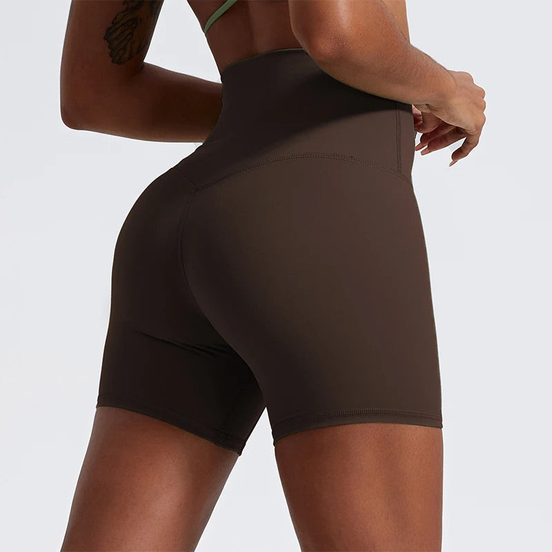 Back view of model wearing brown women’s high-waist cycling shorts – super soft tummy control biker workout shorts