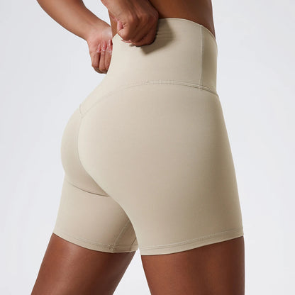 Back view of model wearing light khaki women’s high-waist cycling shorts – super soft tummy control biker workout shorts