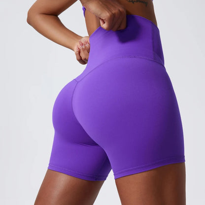 Back view of model wearing purple women’s high-waist cycling shorts – super soft tummy control biker workout shorts