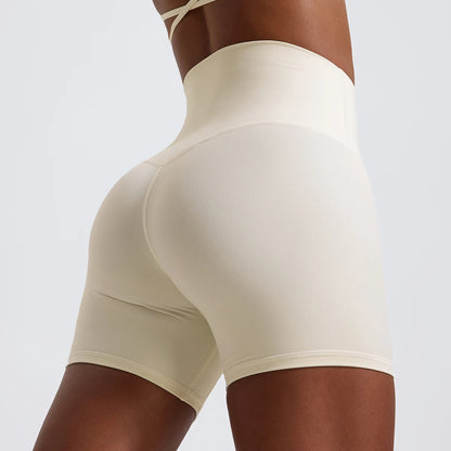 Back view of model wearing sandy white women’s high-waist cycling shorts – super soft tummy control biker workout shorts