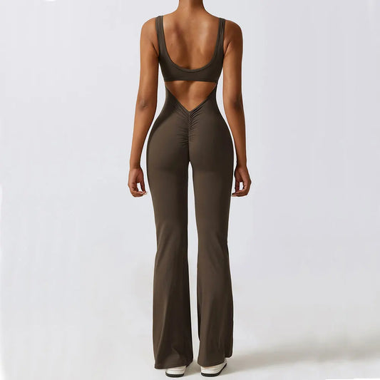 Woman modeling the back view of a charcoal coffee Women's Bodysuit for Working Out, highlighting its sleek fit, open-back design, and flexible, breathable fabric.