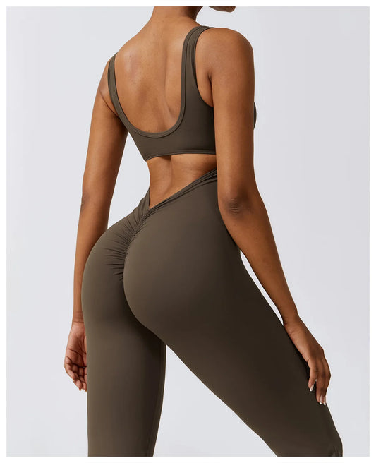Close up back view of model wearing charcoal coffee women’s workout bodysuit – stretchy one-piece romper for yoga and gym