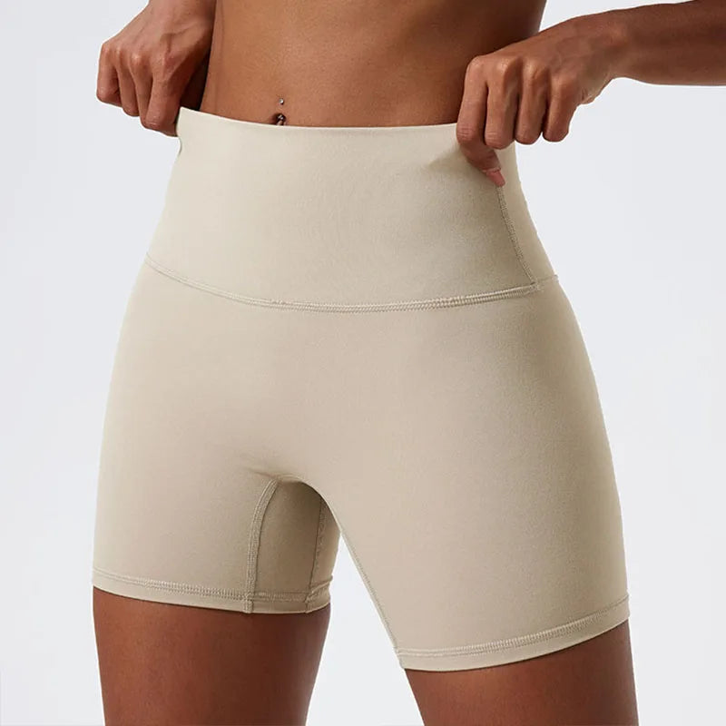 Front view of model wearing light khaki women’s high-waist cycling shorts – super soft tummy control biker workout shorts