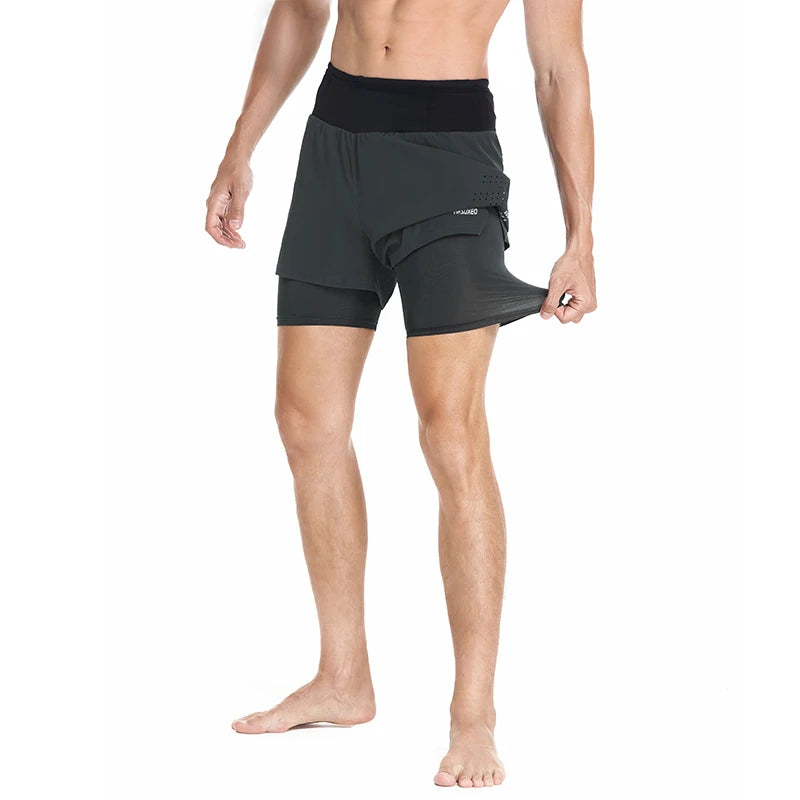 Man modeling the front view of Grey Double Layer High Waist 2 in 1 Running Shorts pulling on compression liner