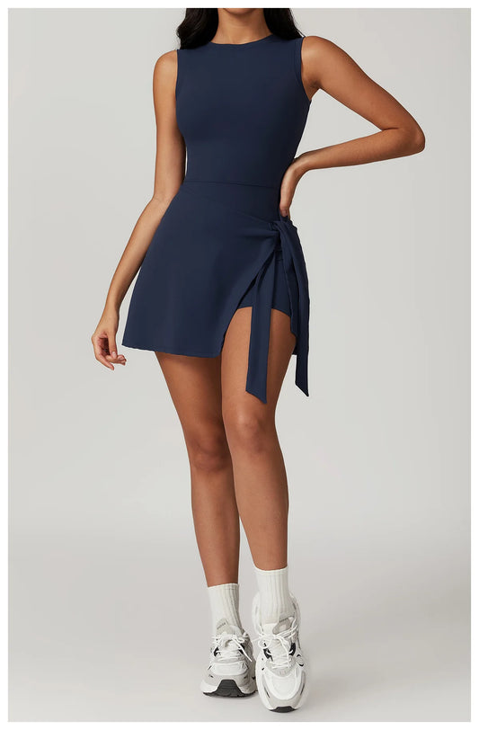 Model wearing emblem blue women’s tennis skirt one-piece – athletic quick-dry sports dress with chest pads
