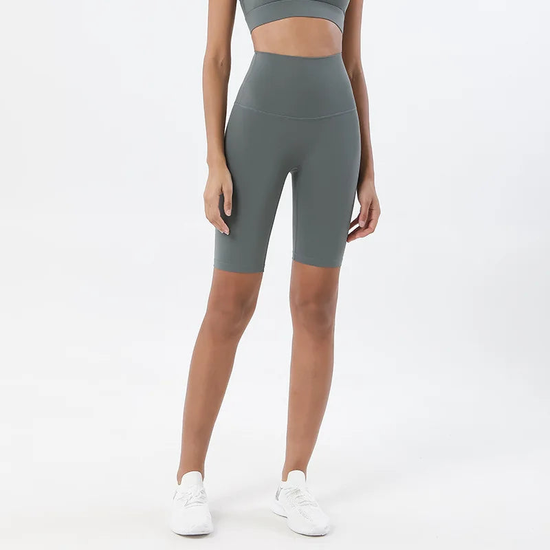 Model wearing bamboo green women’s breathable high-waist cycling shorts, tummy control biker shorts