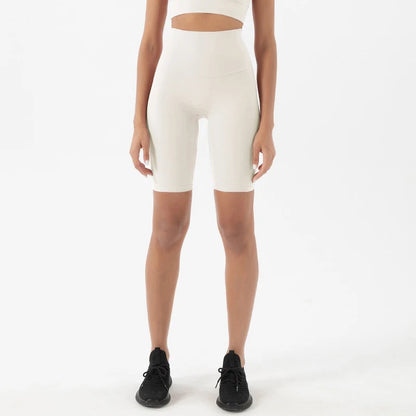 Model wearing white women’s breathable high-waist cycling shorts, tummy control biker shorts