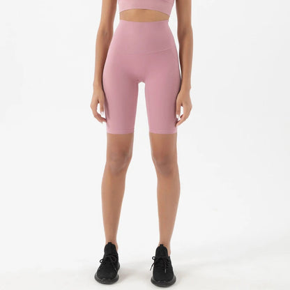 Model wearing pink purple women’s breathable high-waist cycling shorts, tummy control biker shorts