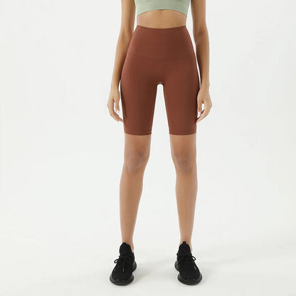 Model wearing brown women’s breathable high-waist cycling shorts, tummy control biker shorts