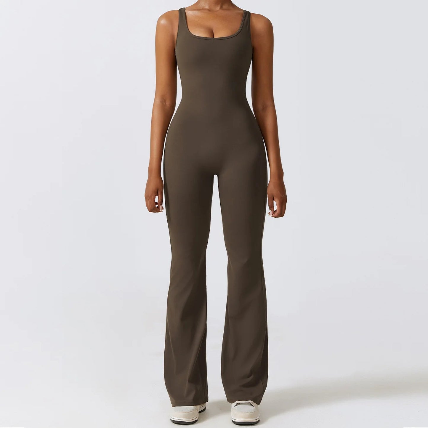Front view of model wearing charcoal coffee women’s workout bodysuit, stretchy one-piece romper